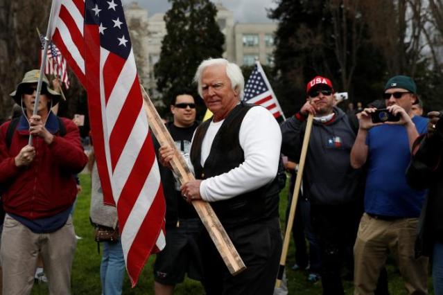 A demonstrator in support of U.S. President Donald Trump holds a stick during a "People 4 Trump" rally in Berkeley, California
